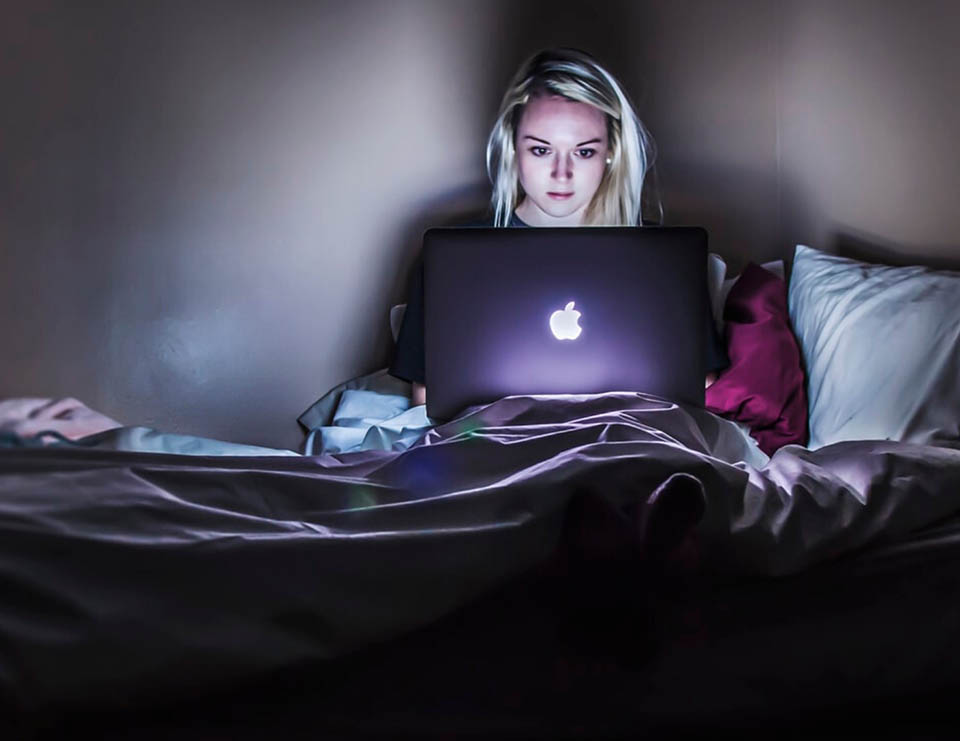 Person searching online from bed